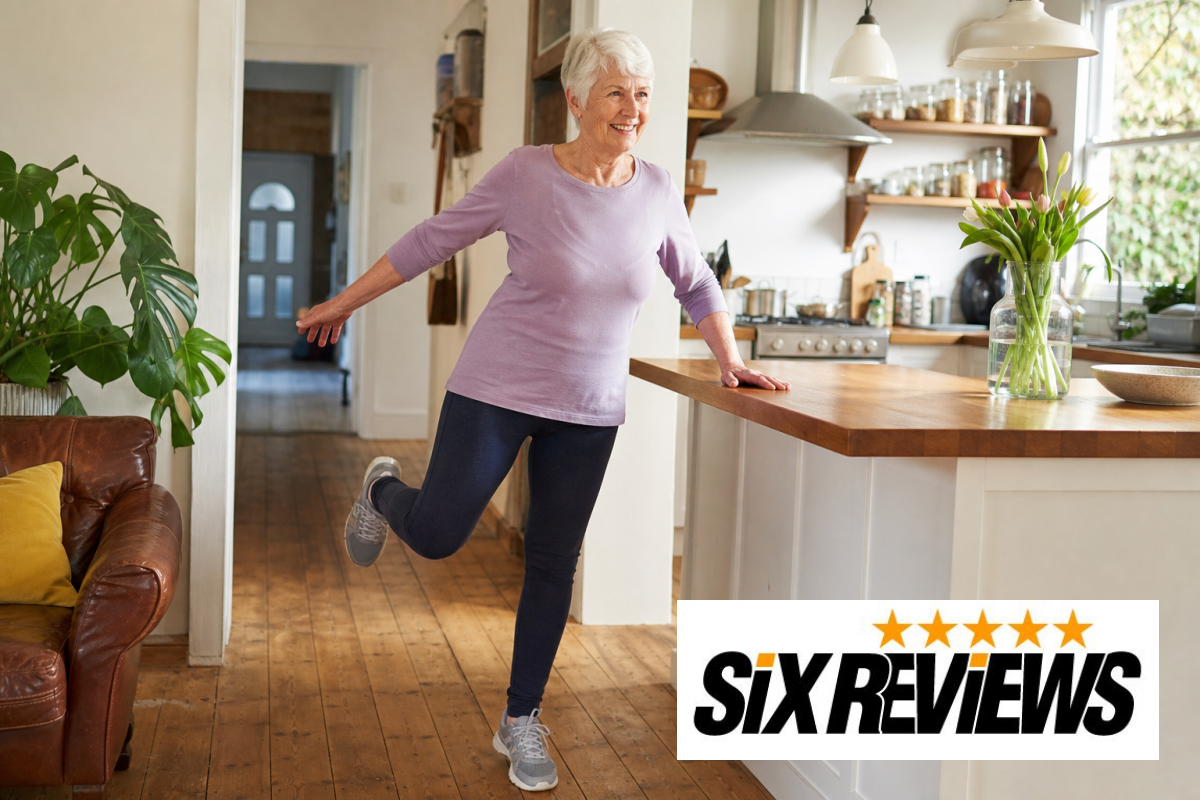 Senior woman smiling while practicing a balance exercise at home