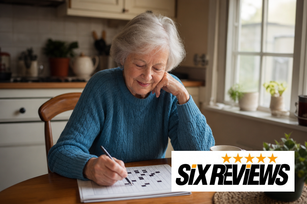 Senior woman solving a crossword puzzle at her kitchen table