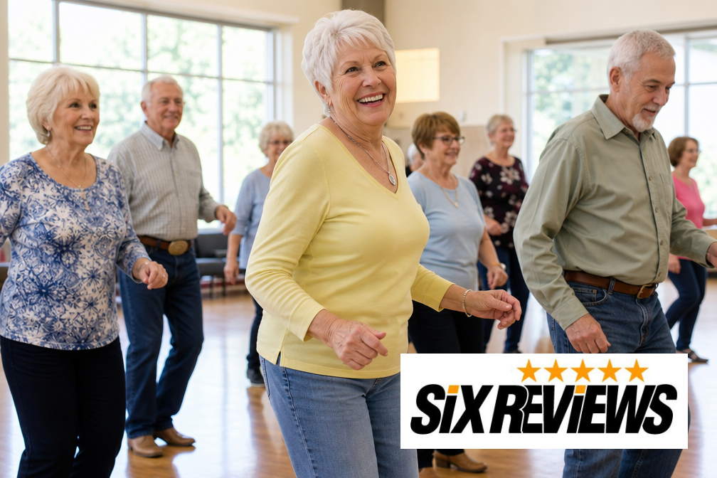 Group of smiling seniors line dancing together in a sunny community center