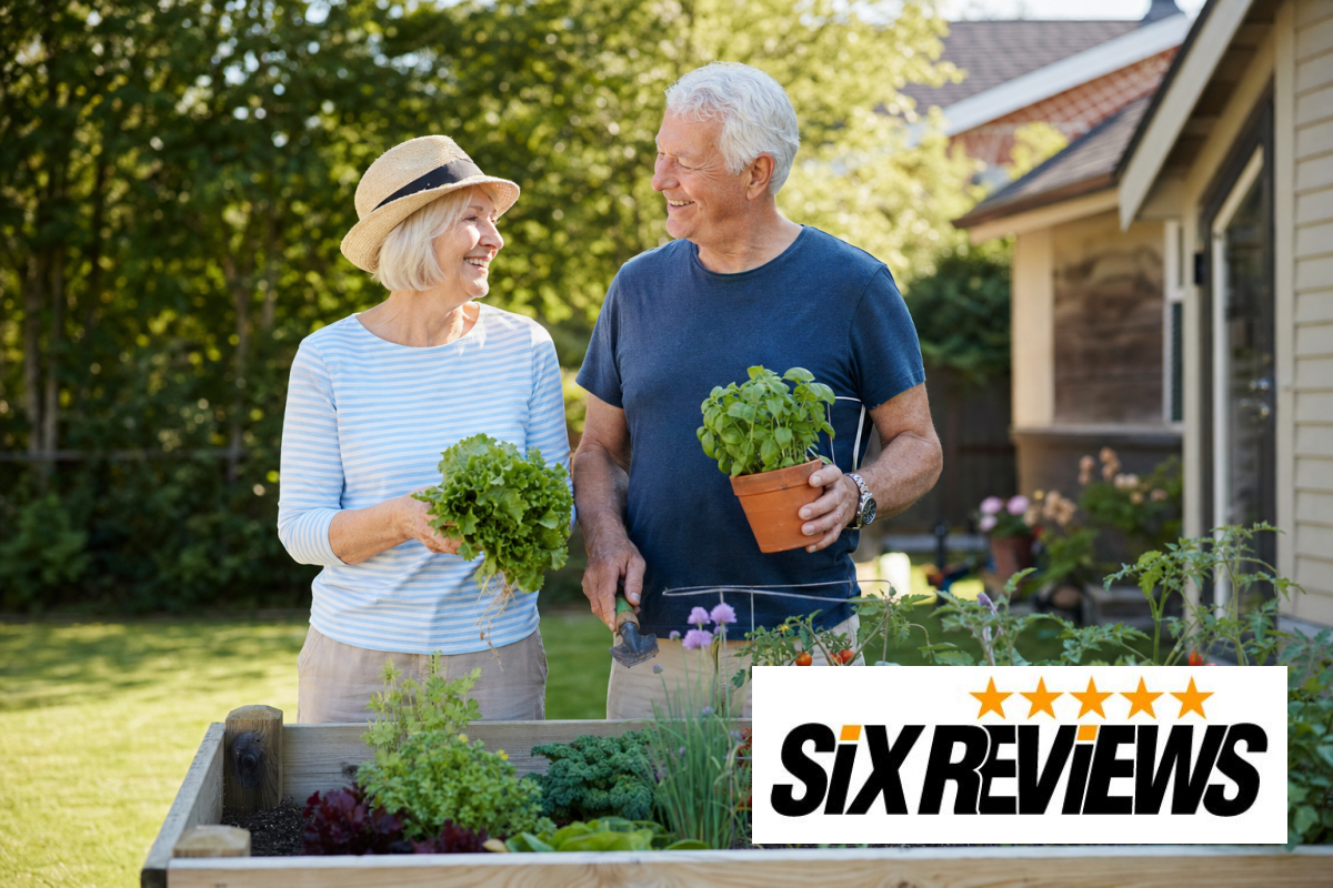 Senior couple standing and tending vegetables in a raised garden bed
